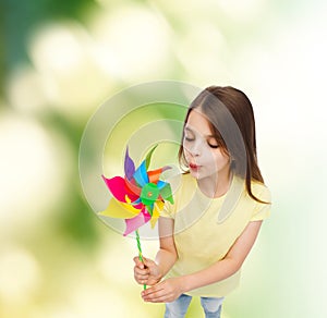 Smiling child with colorful windmill toy