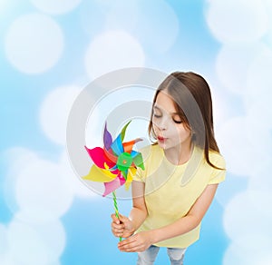 Smiling child with colorful windmill toy