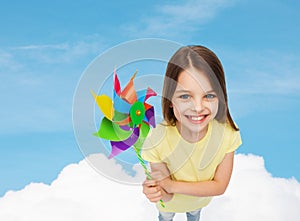 Smiling child with colorful windmill toy