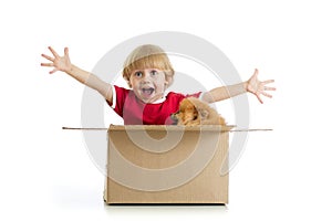 Smiling child and dog in cardbox isolated on white background