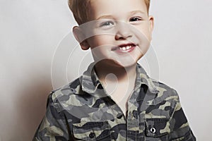 Smiling child. funny little boy. close-up. joy. 4 eyers old. military shirt