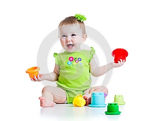 Smiling child girl playing with color toys