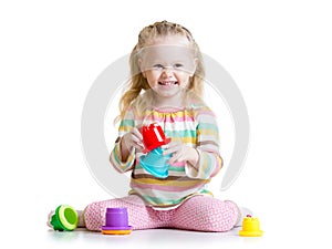 Smiling child girl playing with color toys