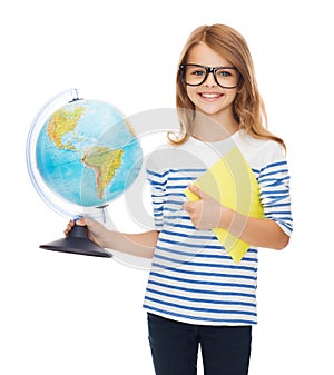 Smiling child with globe, notebook and eyeglasses