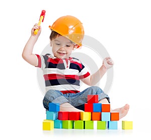 Smiling child with hard hat and toy hammer