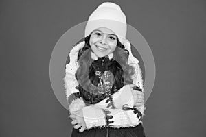 Smiling child in knitted hat. feeling cosy in warm clothes. winter fashion. portrait of pure beauty. small girl long