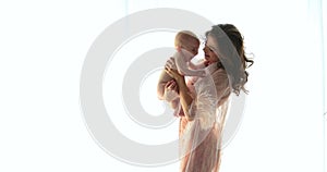 Smiling child with mother on a white background, maternal love and care.