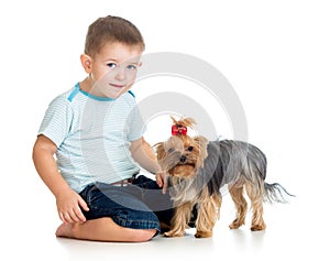 Smiling child playing with a puppy dog