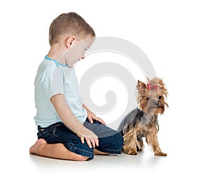 Smiling child playing with a puppy dog