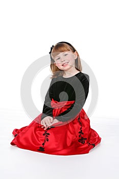 Smiling child in red and black holiday dress