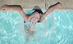 Smiling Child Relaxing in a Swimming Pool