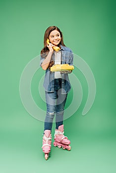 Smiling child in roller blades talking on vintage telephone