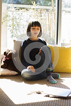 Smiling child sitting home for outbreak and relaxing homeschool learning