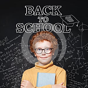 Smiling child smart student on Back to school chalkboard background