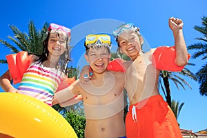 Smiling children in bathing suits