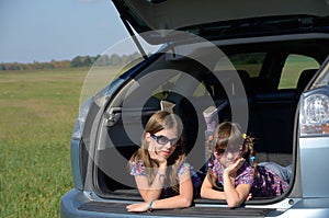 Smiling children in car