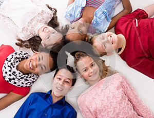 Smiling children with different complexion lying head to head