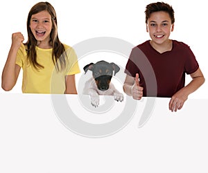 Smiling children with an empty banner, copyspace and a puppy dog