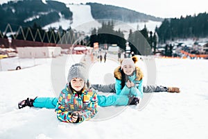 Smiling children enjoying winter vacations in mountains . Ski, Sun, Snow and fun