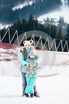 Smiling children enjoying winter vacations in mountains . Ski, Sun, Snow and fun