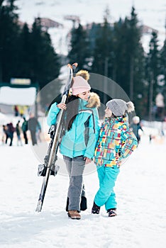 Smiling children enjoying winter vacations in mountains . Ski, Sun, Snow and fun