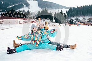 Smiling children enjoying winter vacations in mountains . Ski, Sun, Snow and fun