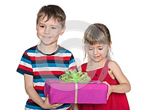 Smiling children hold a gift box