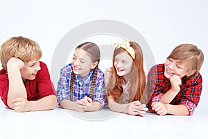 Smiling children lying on the floor in raw