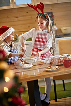 Smiling children making Christmas cookies