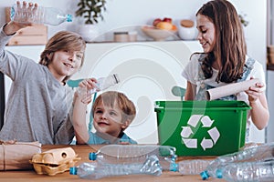 Smiling children segregating plastic bottles