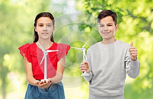 smiling children with toy wind turbine