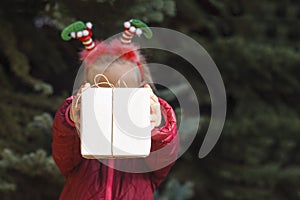 Smiling Christmas child holding a gift box