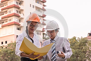 Smiling civil engineer and architect working in a construction s