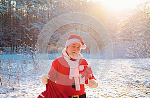 Smiling Claus Santa with Gift on Christmas Eve outside.