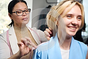 Smiling client at fitting in sewing studio