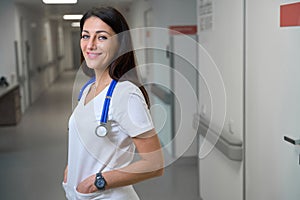 Smiling clinic employee in a bright hospital corridor