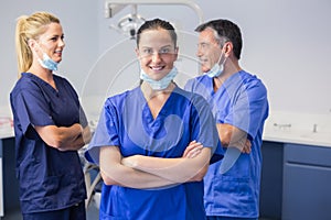 Smiling co-workers talking with arms crossed