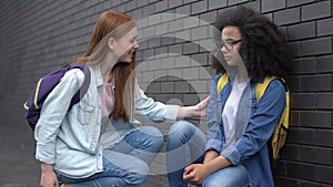 Smiling college student encouraging new classmate taking hand, help assistance