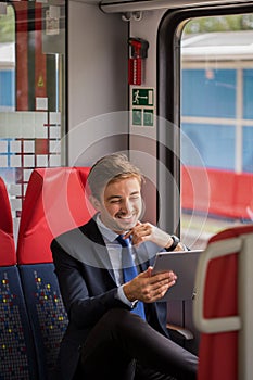 Smiling commuter with tablet