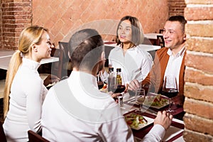 Company of friends eating delicious dinner