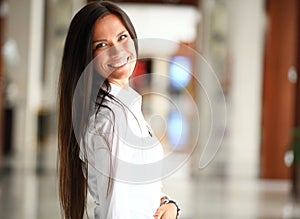 Smiling confident business woman looking at camera