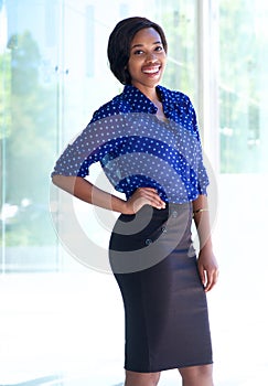 Smiling confident business woman standing outdoors