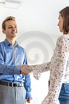 Smiling confident businessman shaking hands