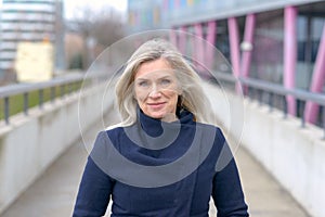 Smiling confident businesswoman walking in town