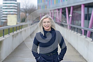 Smiling confident businesswoman walking in town