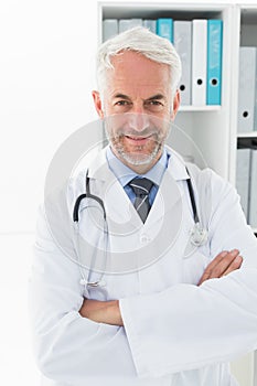 Smiling confident male doctor at medical office