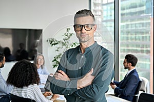 Smiling confident mature businessman leader looking at camera in office.