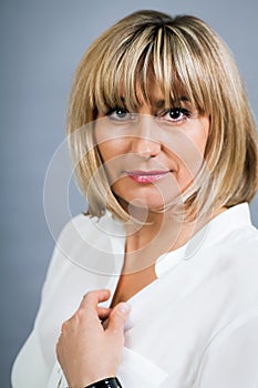 Smiling confident middle-aged blond woman