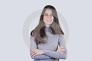 Smiling confident  young  student woman looking to camera holding hands crossed isolated over white background with copy space.