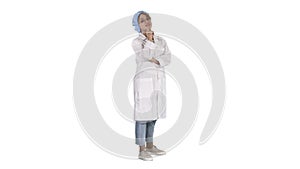 Smiling confident young woman doctor standing with arms crossed over on white background.